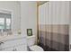 Bright bathroom with a modern vanity, toilet, and a shower with a decorative, neutral shower curtain at 459 Dancing Water Dr, Winter Springs, FL 32708