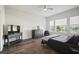 Modern bedroom with wood floors, a tv, and sunny windows at 459 Dancing Water Dr, Winter Springs, FL 32708
