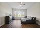 Cozy bedroom with hardwood floors, a ceiling fan, and bright natural light from the large windows at 459 Dancing Water Dr, Winter Springs, FL 32708