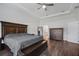 Well-appointed bedroom with a large bed, tray ceilings, and dark wood furniture at 459 Dancing Water Dr, Winter Springs, FL 32708
