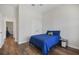 Well-lit bedroom features wood floors and a simple decor with a blue comforter at 459 Dancing Water Dr, Winter Springs, FL 32708
