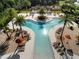 Aerial shot of community pool featuring palm trees, lounge chairs, umbrellas and inviting recreational space for residents at 459 Dancing Water Dr, Winter Springs, FL 32708