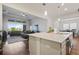 Open-concept kitchen with quartz countertops overlooking the living room, creating a seamless flow for entertaining at 459 Dancing Water Dr, Winter Springs, FL 32708
