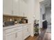 Kitchenette with white cabinets, stainless appliances, and stone countertops at 459 Dancing Water Dr, Winter Springs, FL 32708