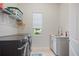 Bright laundry room features modern washer, dryer, and sink with under cabinet storage at 459 Dancing Water Dr, Winter Springs, FL 32708