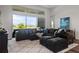 Bright living room featuring a large sofa and a view of the lake at 459 Dancing Water Dr, Winter Springs, FL 32708