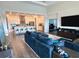 Open concept living room featuring a spacious seating area and modern kitchen with a large island at 459 Dancing Water Dr, Winter Springs, FL 32708