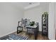 Dedicated home office space with a modern desk, multiple monitors, and a sleek black bookshelf at 459 Dancing Water Dr, Winter Springs, FL 32708