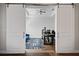 Office space with barn doors, a ceiling fan, a modern desk, and a bright blue couch at 459 Dancing Water Dr, Winter Springs, FL 32708