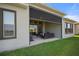 Covered outdoor patio with comfortable seating and a view of the spacious backyard at 459 Dancing Water Dr, Winter Springs, FL 32708
