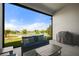 Relax on the patio with beautiful lakeside views and cozy seating arrangement at 459 Dancing Water Dr, Winter Springs, FL 32708