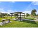 Shaded community picnic area with tables overlooking a lake and landscaped grounds at 459 Dancing Water Dr, Winter Springs, FL 32708