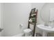 A cute powder room with a floating sink, decor, and a ladder shelf at 459 Dancing Water Dr, Winter Springs, FL 32708
