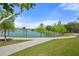 Scenic community lakeside walking path with lush landscaping and serene water views at 459 Dancing Water Dr, Winter Springs, FL 32708