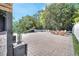 Expansive backyard with brick pavers, outdoor seating area, and manicured landscaping at 460 Crownclover Ave, Orlando, FL 32828