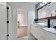 Modern bathroom boasts a stylish vanity, sleek sink, and a view to a bright living area at 460 Crownclover Ave, Orlando, FL 32828