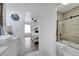 Bathroom view into bedroom with tiled shower, glass door, and modern fixtures at 460 Crownclover Ave, Orlando, FL 32828