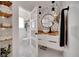 Stylish bathroom with geometric wallpaper, floating vanity, and modern fixtures; a door leads to the toilet area at 460 Crownclover Ave, Orlando, FL 32828