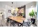 Light and airy dining room showcasing a wooden table, black chairs, and decorative accents at 460 Crownclover Ave, Orlando, FL 32828