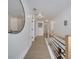 Bright hallway with light wood floors, modern railing, and a large round mirror at 460 Crownclover Ave, Orlando, FL 32828