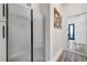 Hallway with wood flooring leads to a well-lit area showcasing stainless steel refrigerator at 460 Crownclover Ave, Orlando, FL 32828
