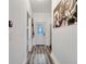 Clean hallway with wood floors, white walls, and a secure pet gate at 460 Crownclover Ave, Orlando, FL 32828
