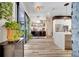 Bright open kitchen featuring wood-look floors, floating shelves, and stainless steel appliances at 460 Crownclover Ave, Orlando, FL 32828