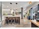 Open kitchen with a large island, stainless steel appliances, and modern lighting at 460 Crownclover Ave, Orlando, FL 32828