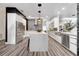 Modern kitchen features a large island, stainless steel appliances, and sleek cabinetry at 460 Crownclover Ave, Orlando, FL 32828