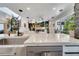Modern kitchen with stainless steel appliances and a large island with waterfall countertops at 460 Crownclover Ave, Orlando, FL 32828