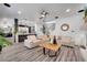 Bright living room opens to the kitchen and features modern decor and wood-look floors at 460 Crownclover Ave, Orlando, FL 32828