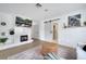 Living room boasts fireplace with modern design and wood flooring at 460 Crownclover Ave, Orlando, FL 32828