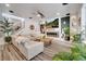 Open concept living room with sleek fireplace, modern decor, and cozy white seating at 460 Crownclover Ave, Orlando, FL 32828