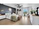 Primary bedroom with accent wall, bright light, and a view of the pond at 460 Crownclover Ave, Orlando, FL 32828