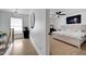 Hallway view into a spacious main bedroom with a moon art piece and minimalist furniture at 460 Crownclover Ave, Orlando, FL 32828
