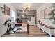 A well-appointed home office boasts custom shelving, modern decor, and luxury vinyl plank flooring at 460 Crownclover Ave, Orlando, FL 32828