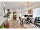 Open-concept space with a home office area featuring a contemporary desk setup and natural light at 460 Crownclover Ave, Orlando, FL 32828