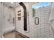 Close-up of a modern shower with a rainfall showerhead, body jets, and a built-in seat at 460 Crownclover Ave, Orlando, FL 32828
