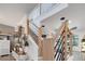 Modern staircase with wood and metal railings, neutral walls, and natural light at 460 Crownclover Ave, Orlando, FL 32828