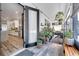 Indoor outdoor space with lots of greenery and leading to a modern kitchen at 460 Crownclover Ave, Orlando, FL 32828