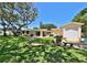 Expansive backyard with lush lawn, mature trees, and patio area, perfect for outdoor entertaining and relaxation at 505 S Cooper St, New Smyrna Beach, FL 32169