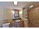 Bathroom with a granite countertop vanity and a glass block shower stall at 505 S Cooper St, New Smyrna Beach, FL 32169