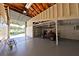 Spacious garage with high ceilings, offering ample room for parking and storage with a golf cart at 505 S Cooper St, New Smyrna Beach, FL 32169