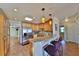 Well-equipped kitchen features a granite countertop bar, stainless steel appliances, and wooden cabinets at 505 S Cooper St, New Smyrna Beach, FL 32169