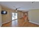 Bright living area boasts wood floors and sliding glass doors to the outdoor patio at 505 S Cooper St, New Smyrna Beach, FL 32169