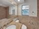 A bathroom with a sink and updated fixtures with a mirrored wall and a window at 5939 Stokes Rd, Lakeland, FL 33812