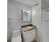 This bathroom features a single vanity, mirror, and a tub/shower combination with updated hardware and fixtures at 5939 Stokes Rd, Lakeland, FL 33812