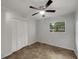 Bedroom with tile flooring, neutral walls, a ceiling fan and closet at 5939 Stokes Rd, Lakeland, FL 33812