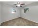 Neutral bedroom featuring tile floors and multiple windows allowing for lots of natural light at 5939 Stokes Rd, Lakeland, FL 33812