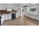 Modern kitchen with white cabinets, tile floors, updated appliances, and lots of storage at 5939 Stokes Rd, Lakeland, FL 33812